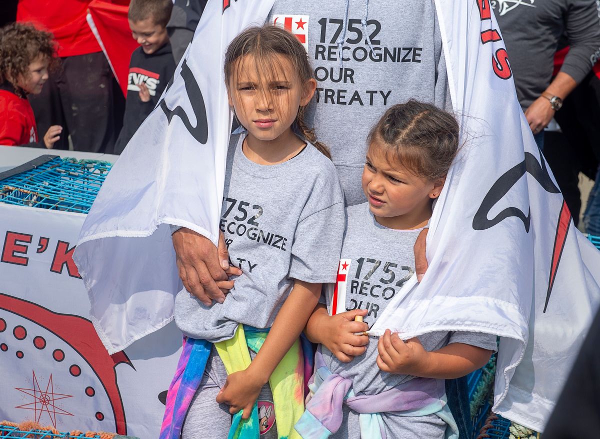 Members of the Sipekne'katik First Nation attend a ceremony on the the wharf in Saulnierville, Nova Scotia.